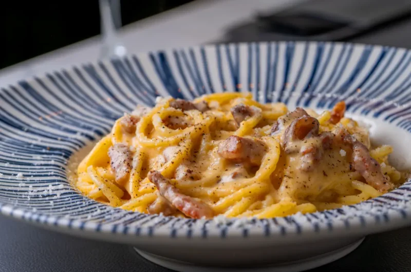 Carbonara recipe with pasta, cheese, black pepper, and cured pork